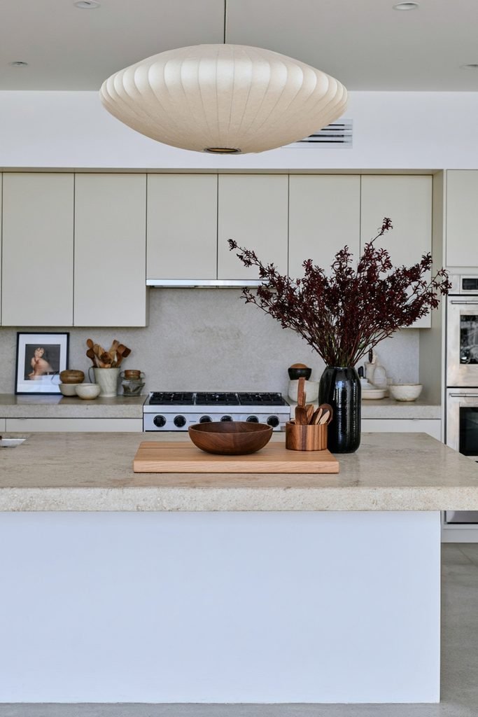 Oak, walnut, and acacia serving pieces styled together on a modern kitchen counter
