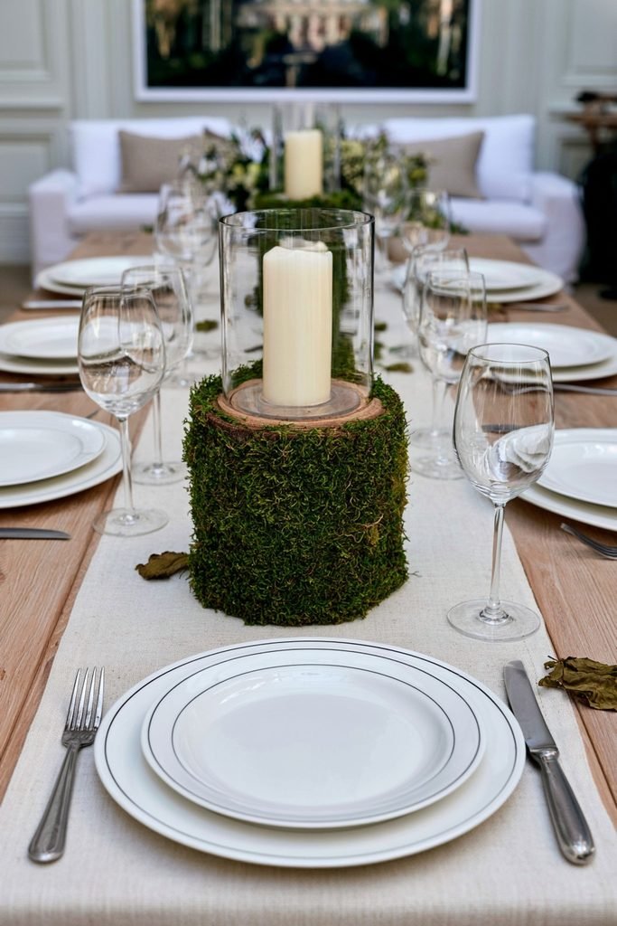 Wood candle holder base wrapped in preserved moss on a fall dining table