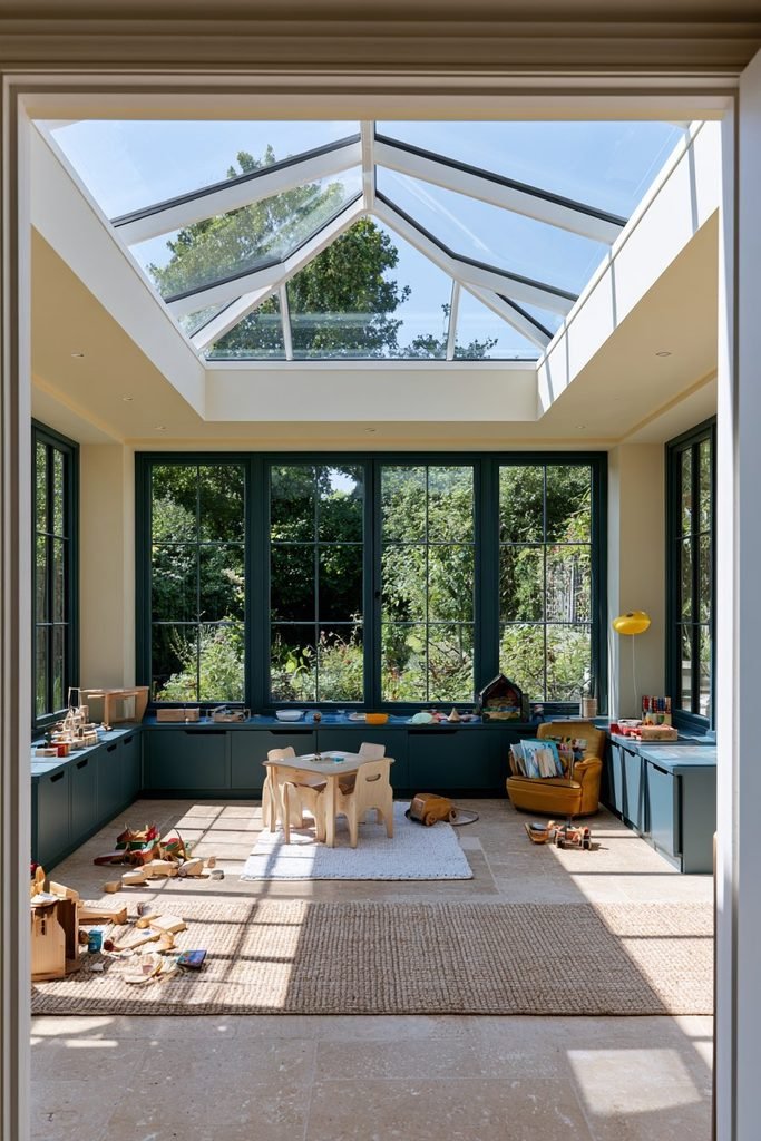 Family orangery playroom with children's storage, toys, seating, and views of the garden.