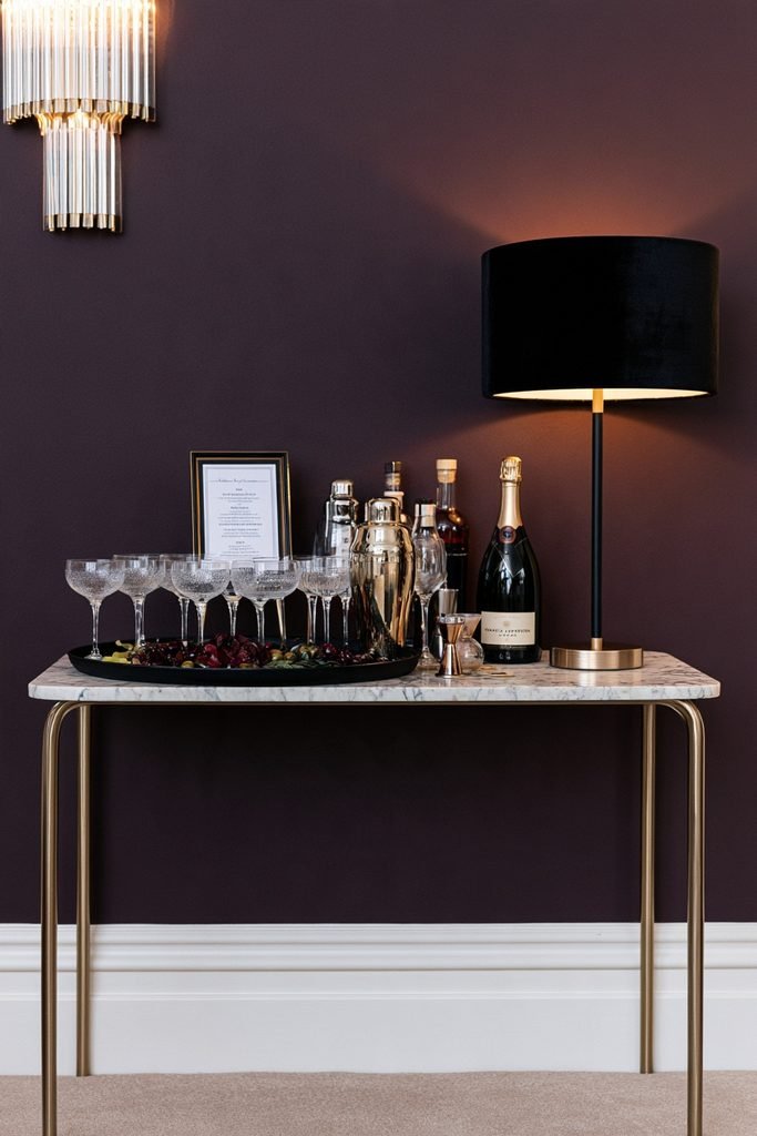 Elegant New Year's Eve cocktail station with signature drinks, champagne, mixers, and glassware