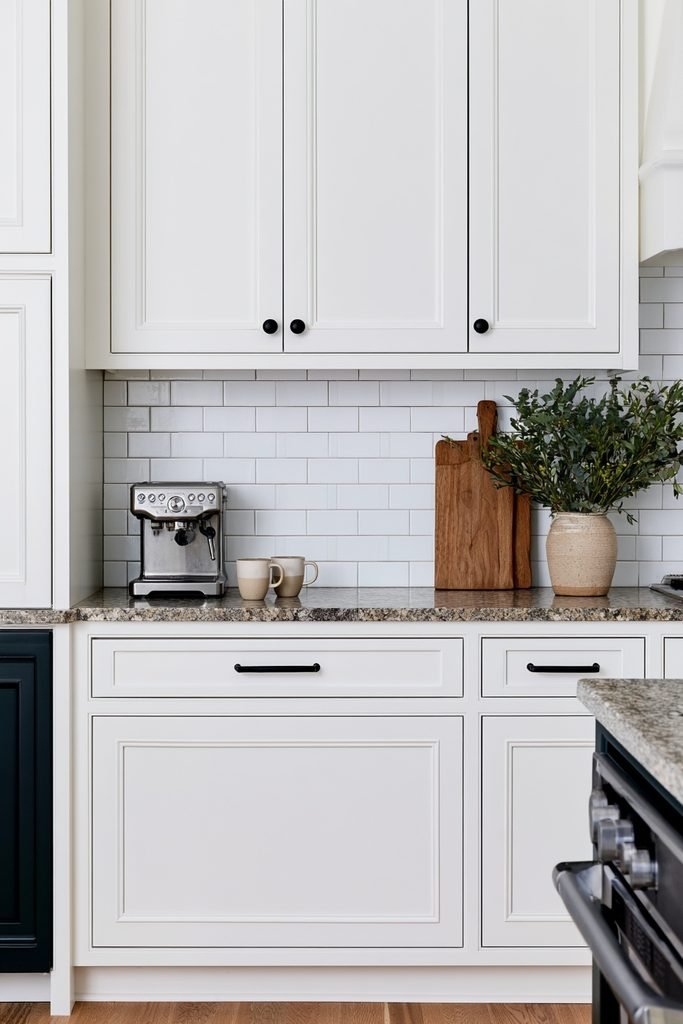 Elegant kitchen backsplash with horizontal subway tiles framed by a vertical soldier course tile border.