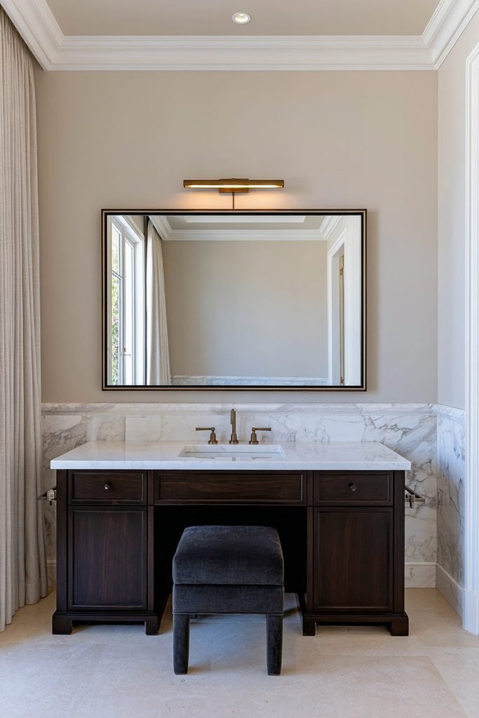 Elegant marble wainscoting in a luxurious bathroom with a freestanding bathtub, polished stone surfaces and brass fixtures