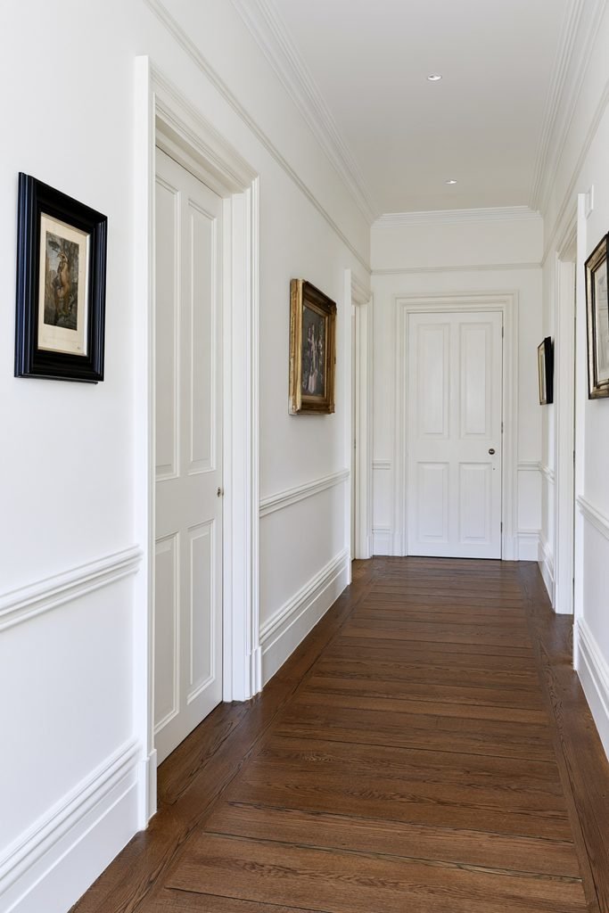 Dado rail paired with a higher picture rail in a traditional hallway