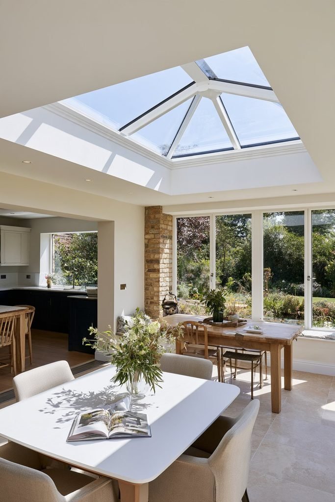 Orangery extension divided into a comfortable window seat and separate dining area.