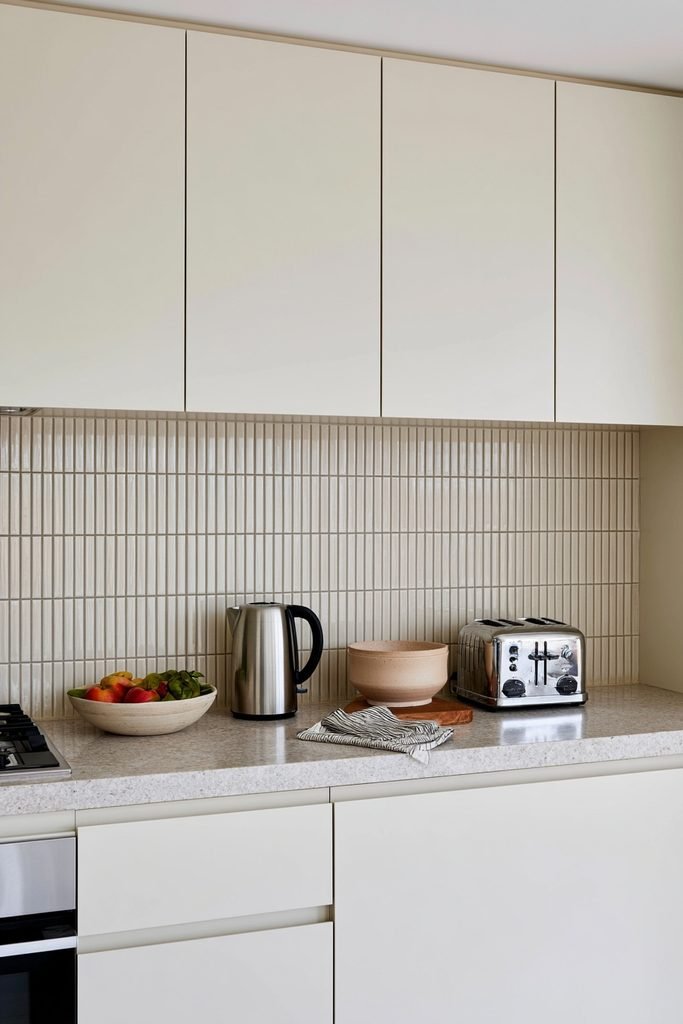 Modern kitchen with vertically stacked subway tiles creating a tall and stylish vertical tile backsplash design.