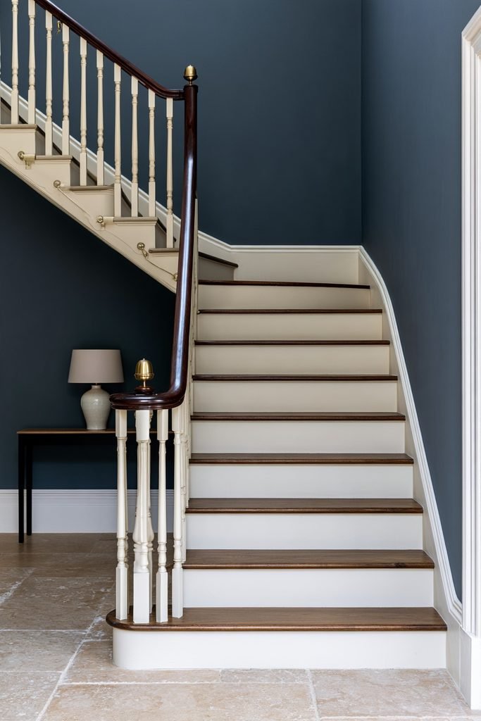 Updated staircase with decorative brushed brass handrail brackets and hardware