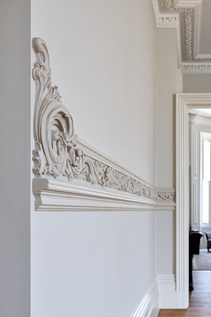 Intricate Victorian dado rail with decorative moulding in a restored heritage interior