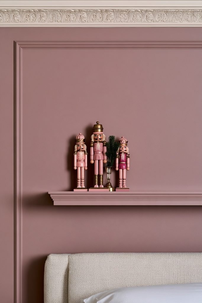 Vintage pink and gold nutcracker decorations styled on a bedroom shelf for Christmas