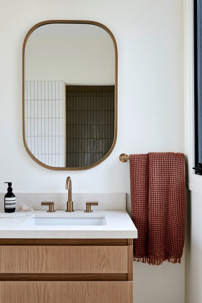 Small bathroom with textured rust-colored towels and warm fall decor
