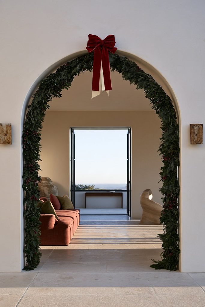 Evergreen Christmas garland decorating an arched doorway in an elegant holiday interior