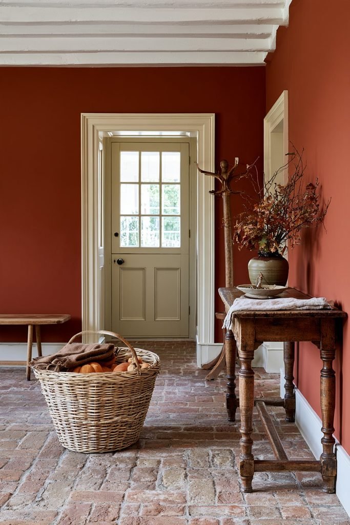 Vintage Thanksgiving entryway featuring a woven harvest basket, antique oak hall table, leaded-glass front door, and traditional Arts and Crafts woodwork.