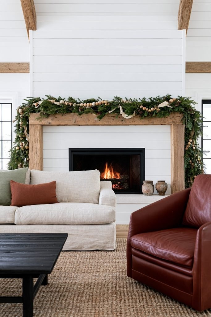 Christmas garland decorated with wooden beads, bells and natural evergreen branches