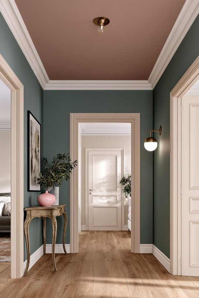 Soft blush pink statement ceiling with white molding and elegant pendant light in a stylish bedroom