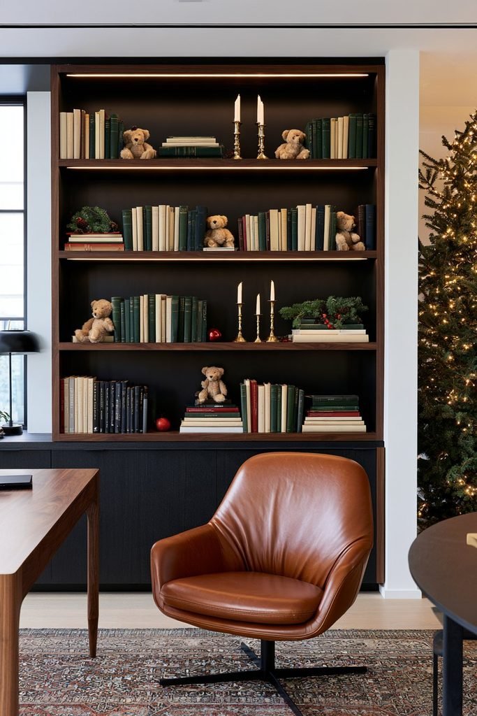 Christmas bookshelf vignette with a teddy bear, stacked books, evergreen sprigs, festive ornaments, and warm seasonal lighting