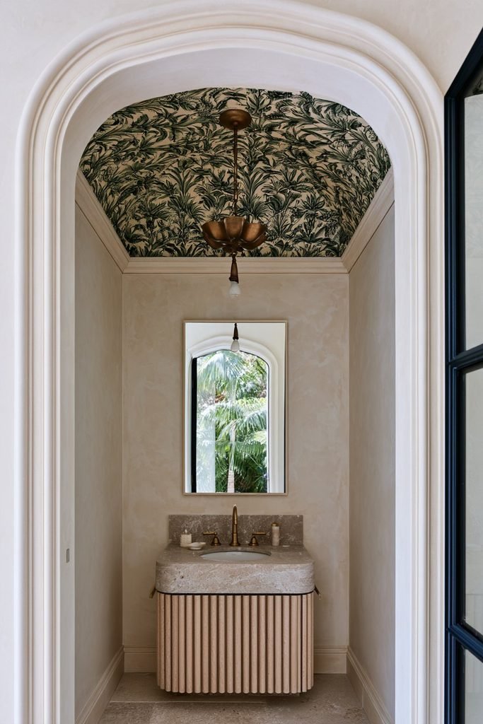Botanical green wallpaper statement ceiling with delicate leaf patterns and brass pendant lighting