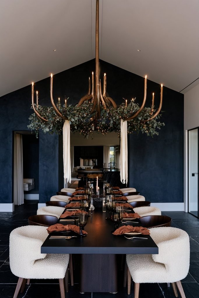 Christmas evergreen garland woven around a chandelier in an elegant dining room