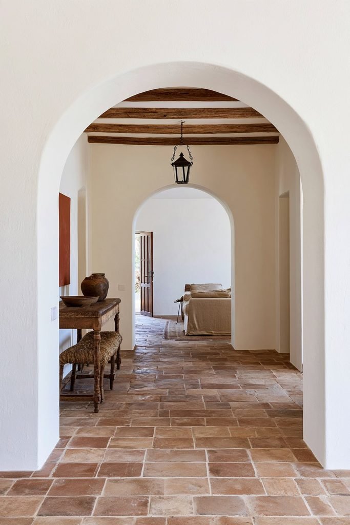 Classic full semicircular doorway in a warm Mediterranean farmhouse interior.