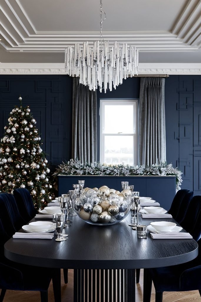 Christmas dining table centerpiece featuring a decorative bowl of festive ornaments on a round smoked-glass table, paired with chrome pedestal styling and elegant seasonal decor.