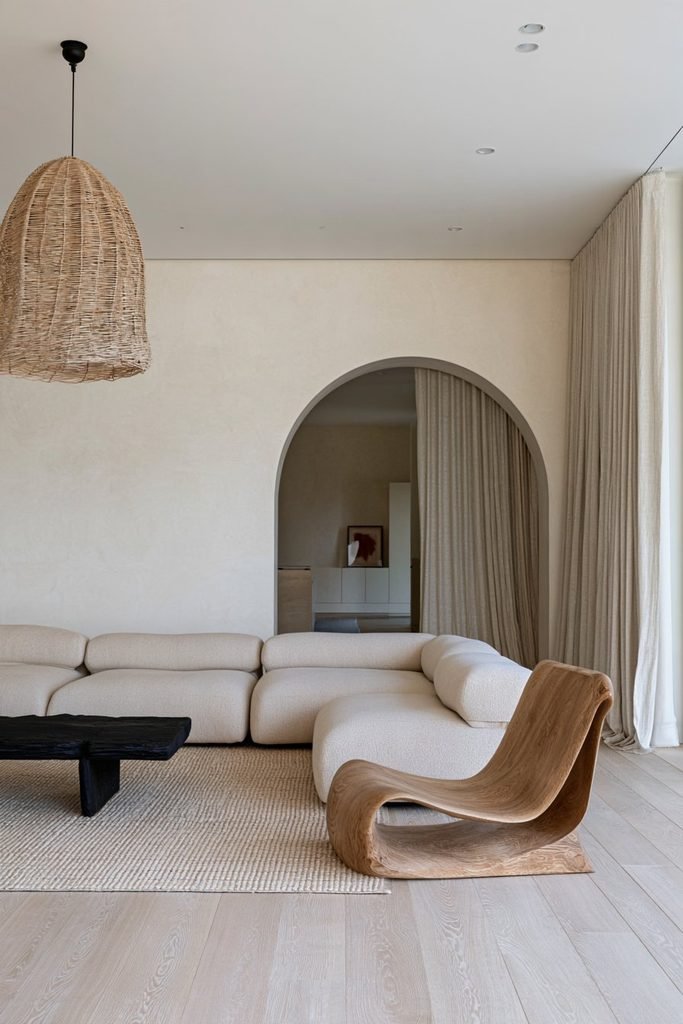 Shallow curved arched doorway softening the clean lines of a modern Japandi living room.